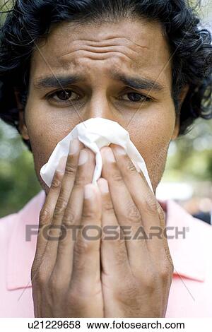 Stock Photo - Man sneezing. Fotosearch