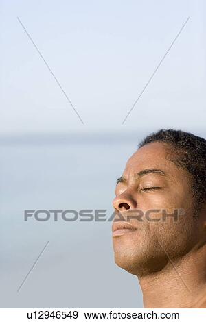Stock Photo - Man sunbathing. Fotosearch