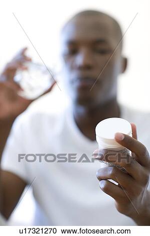 Man taking painkillers View Large Photo Image Stock Image - Man taking painkillers. Fotosearch