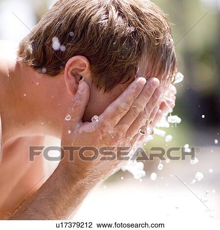 Stock Image - Man washing his face. Fotosearch