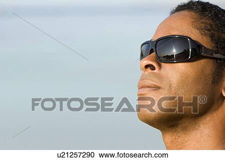 Man wearing sunglasses View Large Photo Image Stock Image - Man wearing sunglasses. Fotosearch