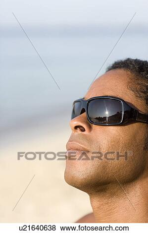 Stock Photo - Man wearing sunglasses. Fotosearch
