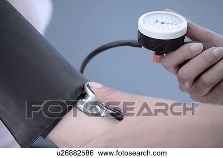 Measuring blood pressure View Large Photo Image Stock Photograph - Measuring blood pressure. Fotosearch