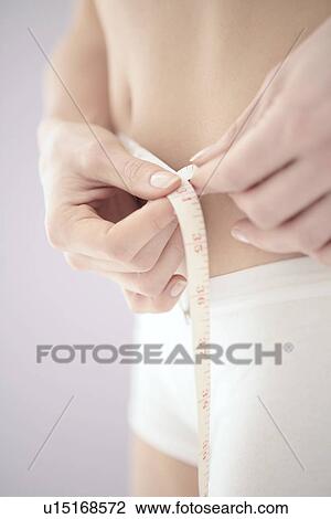Stock Image - Measuring waist. Fotosearch