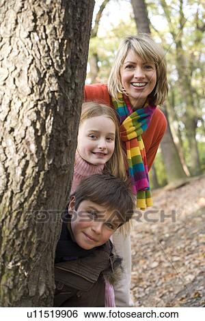 Mother and children playing in a wood View Large Photo Image Stock Photograph - Mother and children playing in a wood. Fotosearch