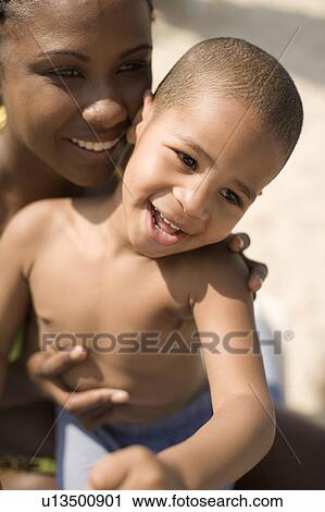 Mother and son at a beach View Large Photo Image Stock Image - Mother and son at a beach. Fotosearch