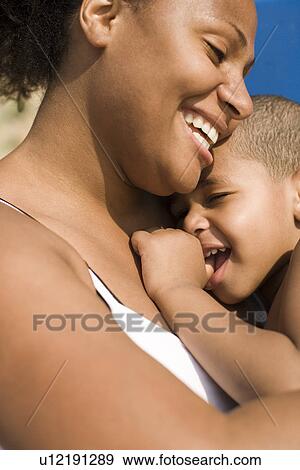 Stock Photo - Mother and son cuddling. Fotosearch