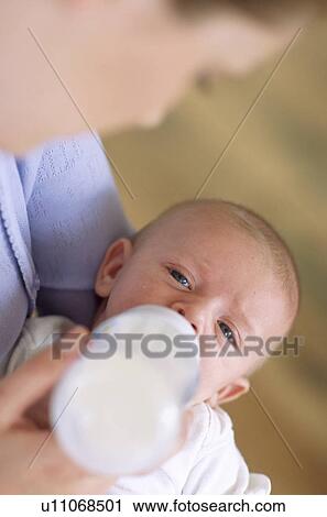 Mother bottle-feeding baby boy View Large Photo Image Stock Image - Mother bottle-feeding baby boy. Fotosearch