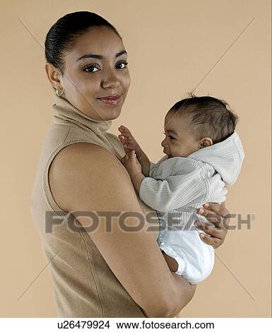 Mother holding her baby View Large Photo Image Picture - Mother holding her baby. Fotosearch