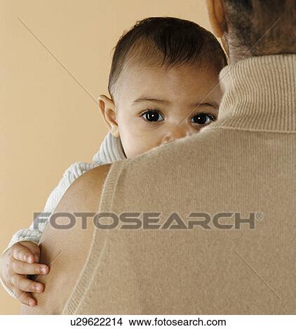 Picture - Mother holding her baby. Fotosearch