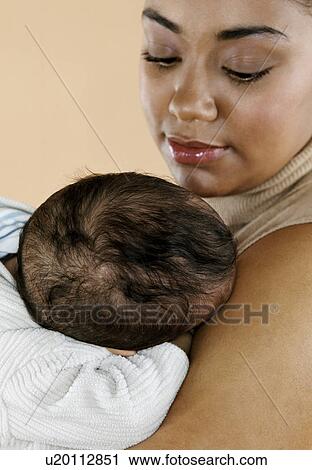Mother with her sleeping baby View Large Photo Image Stock Image - Mother with her sleeping baby. Fotosearch