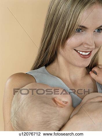Stock Image - Mother with sleeping baby. Fotosearch