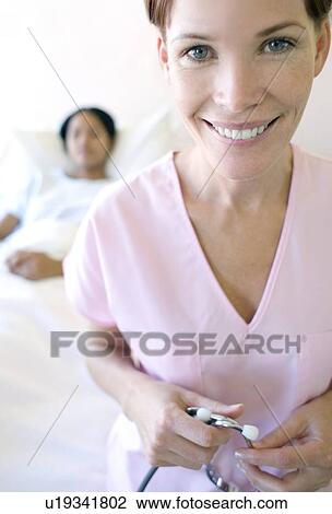 Stock Image - Nurse and patient. Fotosearch