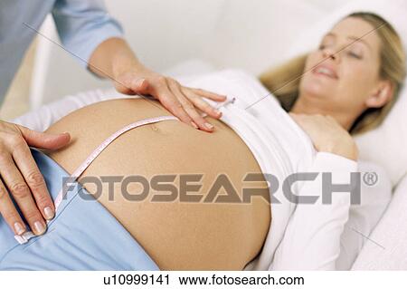 Stock Image - Obstetric examination. Fotosearch