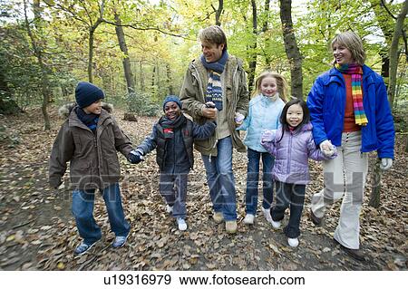 Stock Photo - Parents and children walking in a wood. Fotosearch