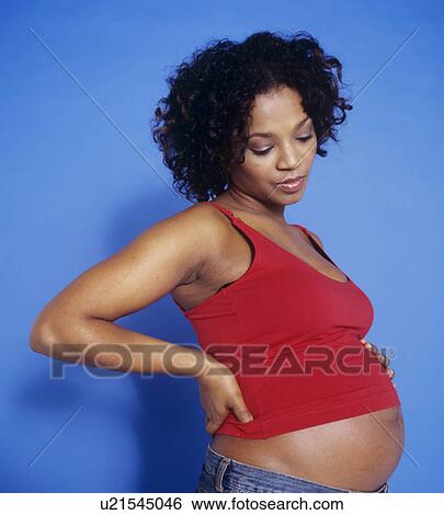 Stock Photograph - Pregnancy back pain. Fotosearch