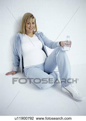 Pregnant woman after exercise View Large Photo Image Stock Image - Pregnant woman after exercise. Fotosearch