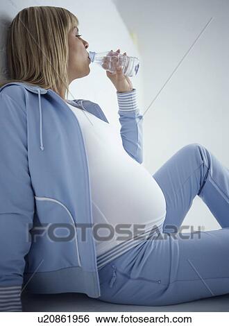 Pregnant woman after exercise View Large Photo Image Stock Photograph - Pregnant woman after exercise. Fotosearch