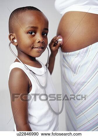 Stock Image - Pregnant woman and son. Fotosearch
