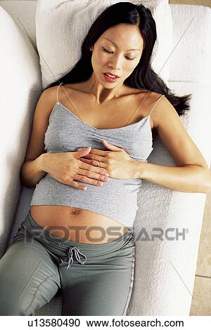 Stock Image - Pregnant woman asleep. Fotosearch