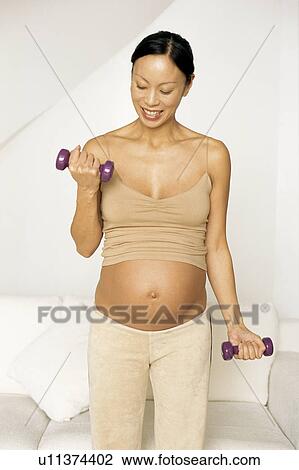 Pregnant woman exercising View Large Photo Image Stock Image - Pregnant woman exercising. Fotosearch