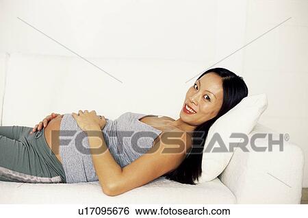 Stock Photograph - Pregnant woman relaxing. Fotosearch