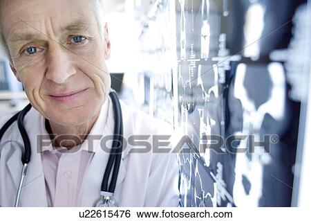 Stock Photograph - Radiologist and CT scans. Fotosearch