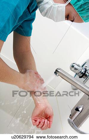 Picture - Scrubbing up before surgery. Fotosearch