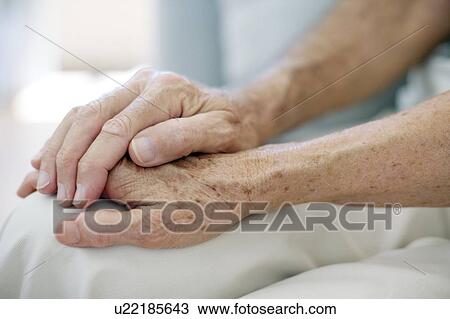 Senior couple holding hands View Large Photo Image Stock Image - Senior couple holding hands. Fotosearch