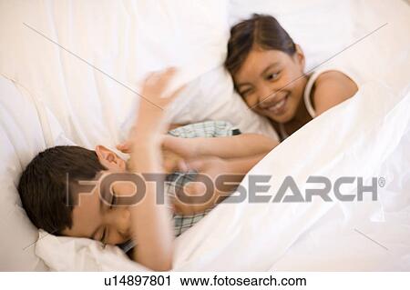 Stock Image - Siblings play fighting. Fotosearch