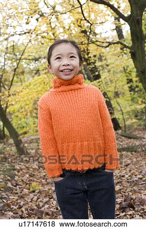 Stock Photo - Smiling girl in a wood. Fotosearch