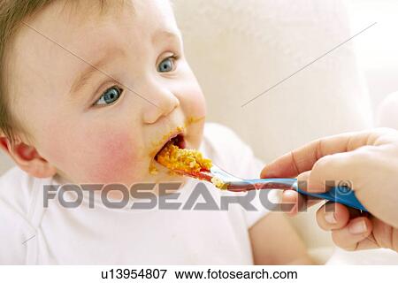 Stock Photo - Spoon-feeding. Fotosearch