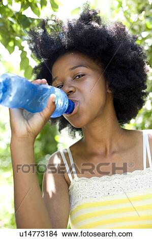 Picture - Teenage girl drinking water. Fotosearch
