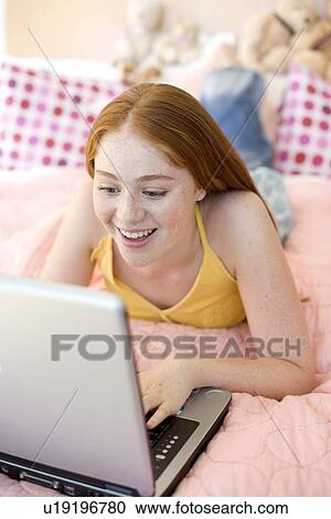 Teenage girl using a laptop computer View Large Photo Image Stock Image - Teenage girl using a laptop computer. Fotosearch