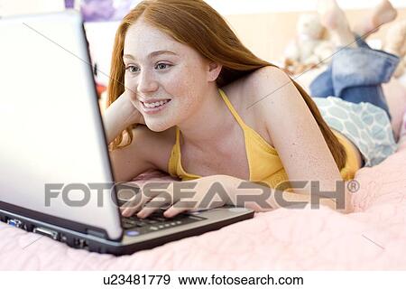 Teenage girl using a laptop computer View Large Photo Image Stock Photo - Teenage girl using a laptop computer. Fotosearch