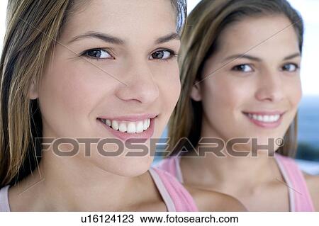 Stock Image - Teenage twin sisters. Fotosearch