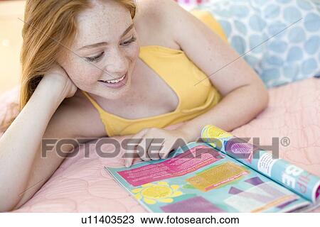 Teenager reading a magazine View Large Photo Image Stock Image - Teenager reading a magazine. Fotosearch