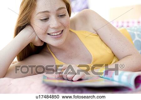 Teenager reading a magazine View Large Photo Image Stock Image - Teenager reading a magazine. Fotosearch