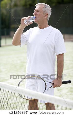 Stock Photo - Tennis player drinking water. Fotosearch