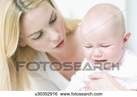 Unhappy baby View Large Photo Image Stock Photograph - Unhappy baby. Fotosearch