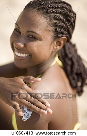 Woman applying sun cream View Large Photo Image Stock Image - Woman applying sun cream. Fotosearch