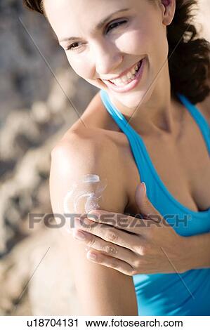 Woman applying sunscreen View Large Photo Image Stock Image - Woman applying sunscreen. Fotosearch