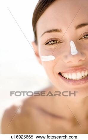 Woman applying sunscreen View Large Photo Image Stock Photography - Woman applying sunscreen. Fotosearch