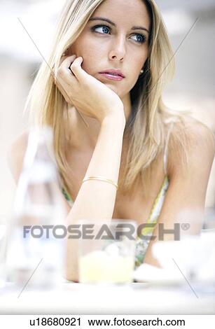 Woman at a table View Large Photo Image Stock Image - Woman at a table. Fotosearch