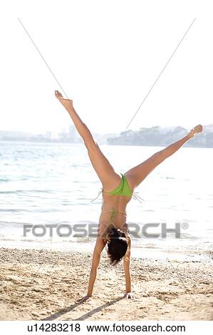 Woman doing a cartwheel View Large Photo Image Stock Photo - Woman doing a cartwheel. Fotosearch
