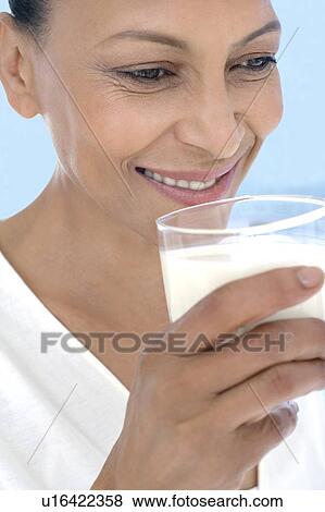 Woman drinking milk View Large Photo Image Stock Photo - Woman drinking milk. Fotosearch
