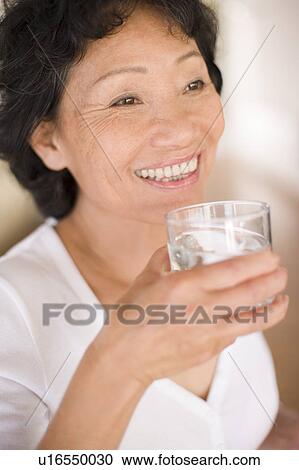 Woman drinking water View Large Photo Image Stock Image - Woman drinking water. Fotosearch