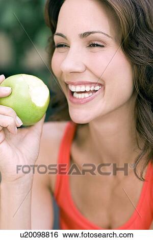 Stock Photograph - Woman eating an apple. Fotosearch
