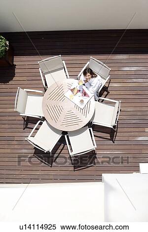 Stock Photography - Woman eating breakfast. Fotosearch