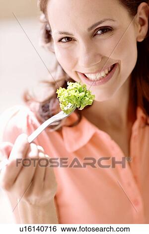 Woman eating lettuce View Large Photo Image Stock Photograph - Woman eating lettuce. Fotosearch
